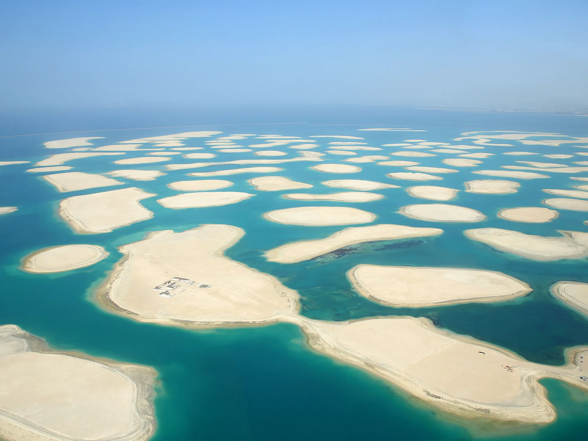 Aerial view of many sandbanks spread across a shallow coastline